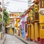 Colorful colonial streets in Cartagena's Walled City with balconies overflowing with flowers
